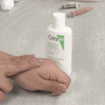 CeraVe Hydrating Facial Cleanser 88ml travel size bottle for normal to dry skin with hand applying cleanser on skin, gentle fragrance free face wash with ceramides.