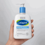 Hand holding Cetaphil Gentle Skin Cleanser 500ml bottle, soap free gentle face and body cleanser for dry to normal sensitive skin.