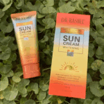 Dr Rashel Sun Cream Whitening SPF 75 60g sunscreen with box packaging placed on green leaves, providing UVA UVB protection, oil control, waterproof sunblock for daily use.