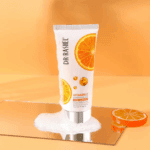 Dr Rashel Vitamin C Facial Cleanser tube with orange slices and foam, brightening and anti aging face wash with hyaluronic acid for fresh glowing skin.