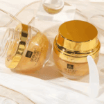 Two jars of Dr. Rashel 24K Gold Collagen Anti-Wrinkle Gel Cream displayed on a soft, elegant surface with decorative elements, highlighting its anti-aging benefits and luxurious gold packaging.