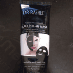 Dr. Rashel black peel-off charcoal mask tube for blackhead removal and deep pore cleansing, front view of skincare product packaging