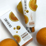 Dr. Rashel Vitamin C Private Part Whitening Cream tube and box placed alongside fresh oranges, highlighting citrus-inspired packaging and brightening skincare benefits.