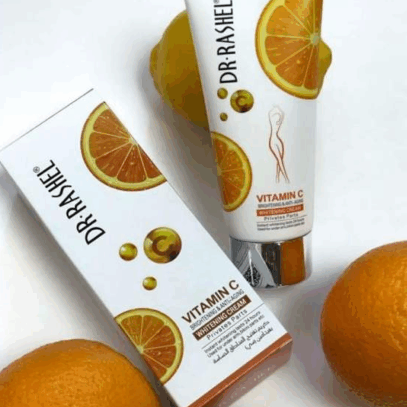 Dr. Rashel Vitamin C Private Part Whitening Cream tube and box placed alongside fresh oranges, highlighting citrus-inspired packaging and brightening skincare benefits.