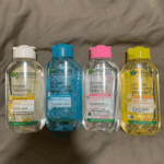 Four Garnier Micellar Cleansing Water bottles including Salicylic BHA, Vitamin C and All in 1 variants, makeup remover and cleanser for different skin types.