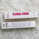 K-Secret Seoul 1988 Eye Cream 30ml box packaging displayed on a soft white fur background showing front and back sides.