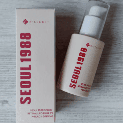 K-Secret Seoul 1988 Retinal Liposome 2% + Black Ginseng Serum 30ml bottle placed next to its box packaging on a light wooden surface.