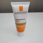 Standing tube of La Roche-Posay Anthelios XL SPF 50 sunscreen with anti-shine dry-touch gel-cream on a white surface.