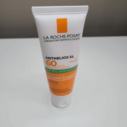 Standing tube of La Roche-Posay Anthelios XL SPF 50 sunscreen with anti-shine dry-touch gel-cream on a white surface.
