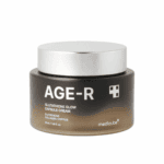 Jar of Medicube AGE-R Glutathione Glow Capsule Cream (50 ml) with a silver lid and black-to-gold gradient container, displayed on a white background.