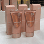 Medicube Collagen Firming Sun Cream SPF50+ PA++++ sunscreen with product boxes.