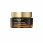 Medicube Deep Vita C Capsule Cream brightening moisturizer in a dark amber jar with a gold lid on a white background.