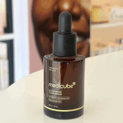 Medicube Glutathione Glow Serum 30g brightening serum bottle with dropper on wooden table.