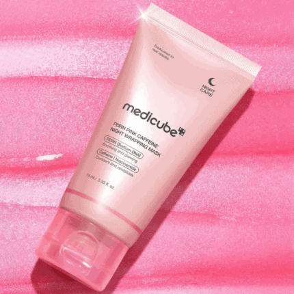 Medicube PDRN Pink Caffeine Night Wrapping Mask 75ml pink tube placed on a textured pink background, highlighting overnight skincare with PDRN, caffeine, and niacinamide.