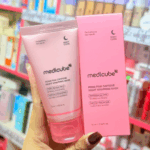Hand holding Medicube PDRN Pink Caffeine Night Wrapping Mask 75ml tube and matching pink product box with PDRN, caffeine, and niacinamide for overnight skin care.