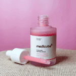 Medicube PDRN Pink Peptide Serum bottle with dropper showing pink collagen peptide serum texture.
