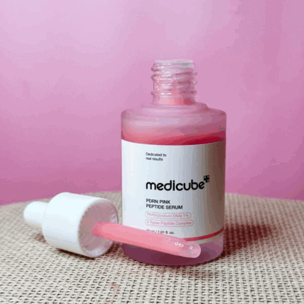 Medicube PDRN Pink Peptide Serum bottle with dropper showing pink collagen peptide serum texture.