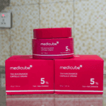 Medicube TXA Niacinamide Capsule Cream 5% jar displayed with product boxes.