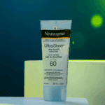 Neutrogena Ultra Sheer Dry-Touch Sunscreen SPF 60 88ml tube on display platform with soft lighting and green gradient background skincare product showcase