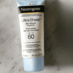 Neutrogena Ultra Sheer Dry-Touch Sunscreen SPF 60 88ml tube on marble surface