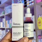 Hand holding The Ordinary AHA 30% BHA 2% Peeling Solution 30ml bottle with product box in skincare store